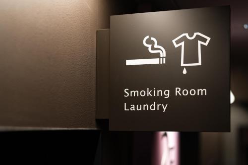 a sign in a bathroom with a smoking room laundry at The OneFive Kyoto Shijo in Kyoto