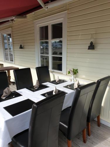 a table with black chairs and a white table cloth at Hotell Ramudden in Gävle