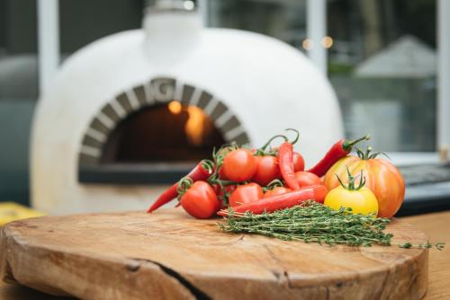 a pile of tomatoes and other vegetables on a cutting board at The Spa Hotel in Royal Tunbridge Wells