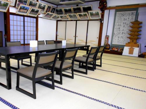 a dining room with a table and chairs at Hagurosan Sankouin / Vacation STAY 40373 in Tsuruoka