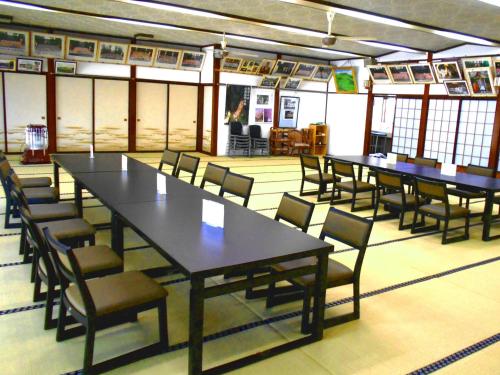 a group of tables and chairs in a room at Hagurosan Sankouin / Vacation STAY 40373 in Tsuruoka