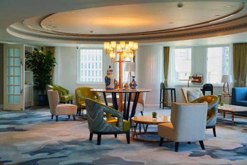 a lobby with chairs and tables in a hotel at Radisson Collection Hotel, Xing Guo Shanghai in Shanghai