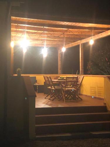 a patio with chairs and a table at night at Appartamenti Sterlizia 2 in Lacona