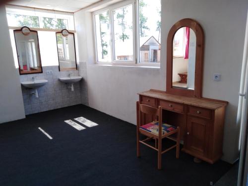 a bathroom with two sinks and a mirror at Family Bungalows & Camp in Vrchlabí