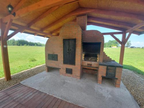 a brick oven sitting on top of a deck at Przystanek Czapla in Czaplinek