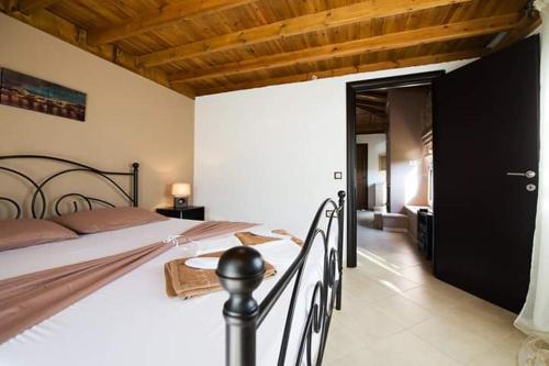 a bedroom with a large bed with a wooden ceiling at Elisabeth Luxury Villas in Vourvourou