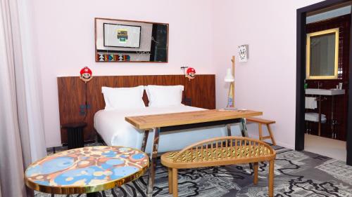 a bedroom with a bed and a table and chairs at Mama Shelter Luxembourg in Luxembourg