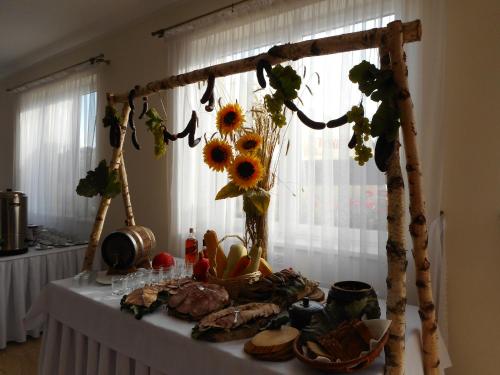 a table with sunflowers and other foods on it at Przystanek Czapla in Czaplinek