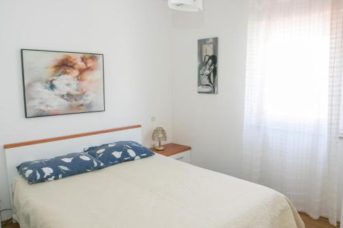 a bedroom with a bed with a pillow on it at Lavanda Apartment in Fažana