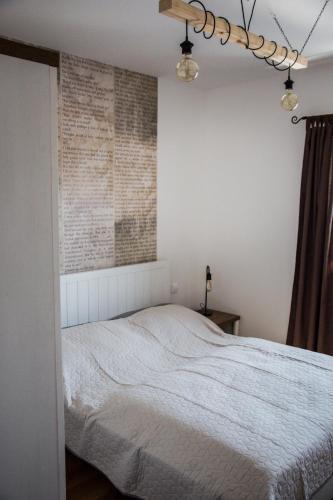 a bedroom with a bed and a brick wall at Apartmány na náměstí in Šumperk