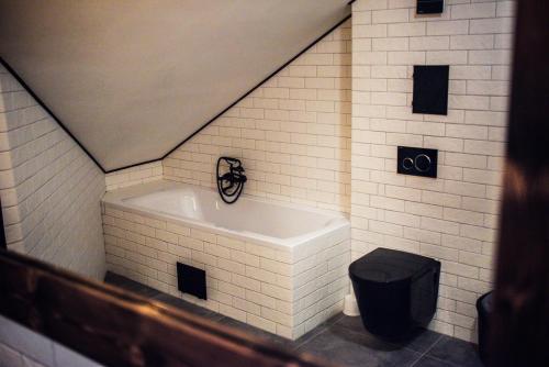 a bathroom with a tub and a toilet at Apartmány na náměstí in Šumperk