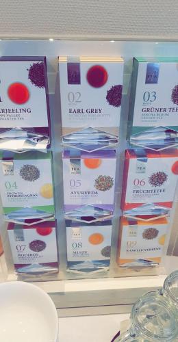 a bunch of boxes of hair care products on a shelf at Landhotel Klempau in Lübeck