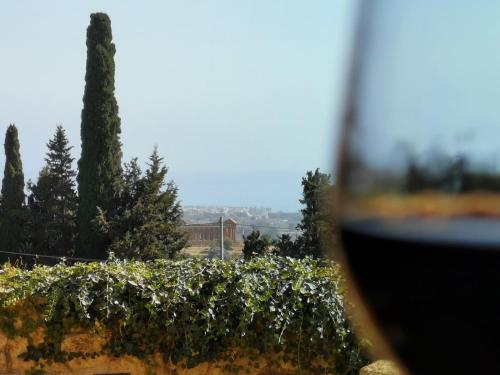 a view of a garden with trees and a wine glass at Villa La Lumia B&B Suites & Apartments in Agrigento