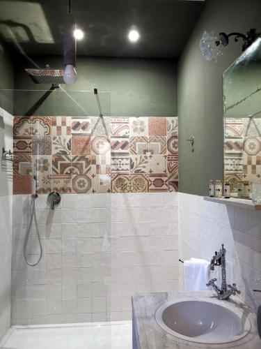 a bathroom with a sink and a shower at Villa La Lumia B&B Suites & Apartments in Agrigento