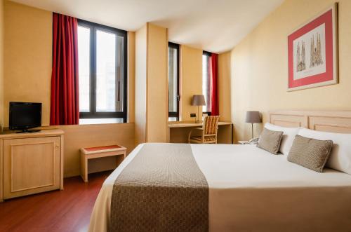 a hotel room with a large bed and a window at Sunotel Junior in Barcelona