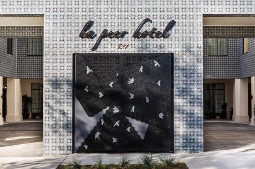 a building with a sign that reads do perilt at Kimpton La Peer Hotel West Hollywood by IHG in Los Angeles