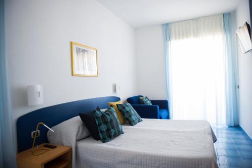 a bedroom with a bed with a blue headboard at Residence Panoramic in Maiori