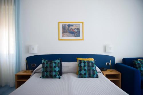 a bedroom with a blue bed with pillows at Residence Panoramic in Maiori