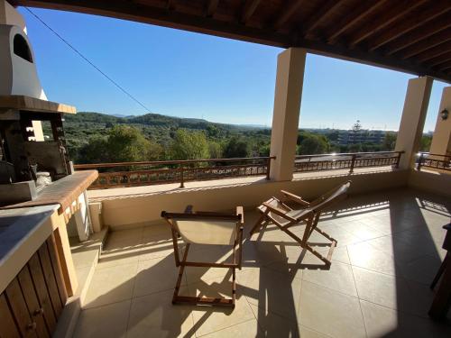 a pair of chairs on the balcony of a house at Theologos Traditional House in Theologos
