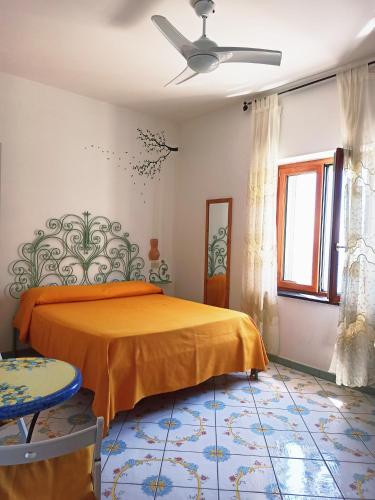 a bedroom with a bed and a ceiling fan at Filù Rooms Paradise Tower in Minori