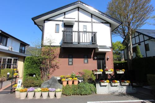 a house with flower pots in front of it at Ururun Kawaguchiko in Fujikawaguchiko
