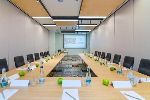 a conference room with a long table with bottles on it at ibis Styles Bucharest City Center in Bucharest