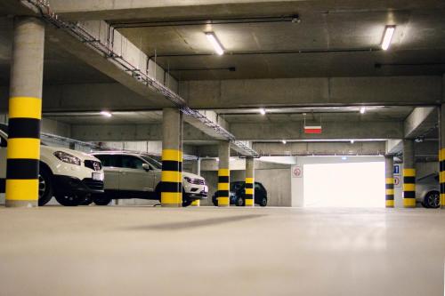 a parking garage with cars parked in it at Ruben Hotel Zielona Góra in Zielona Góra