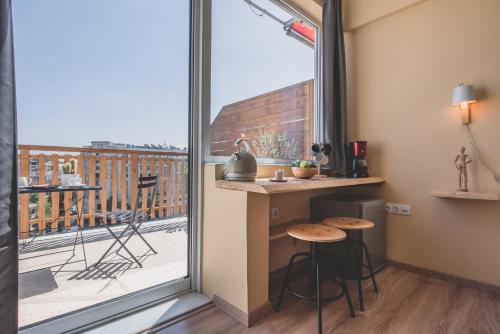una piccola cucina con vista su un balcone di Acropolis View - Living Stone Sapphire Apartment ad Atene