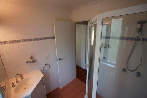a bathroom with a shower and a sink and a shower at Byron Bay Accom Unit 3 41 Childe Street - Belongil Beach Apartment in Byron Bay