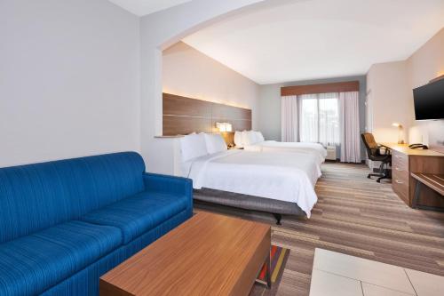 a hotel room with a bed and a couch at Holiday Inn Express Hotel & Suites Warminster-Horsham by IHG in Warminster