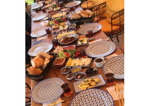 a long table with plates of food on it at Vigneron Cave Hotel in Nevsehir