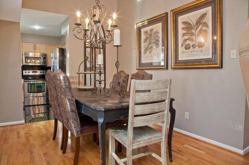a dining room with a wooden table and chairs at Onyx Hotels in Austin