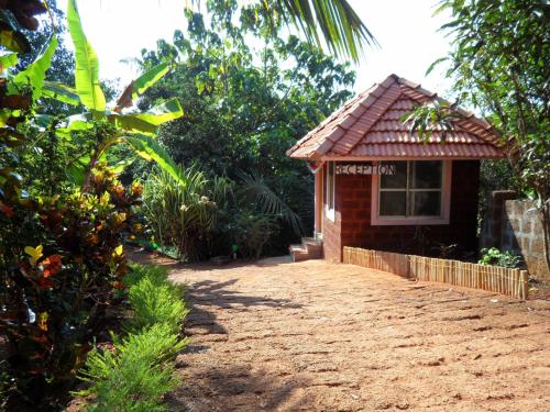 a small building with a sign on the side of it at Namaste Yoga Farm in Gokarna