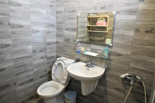 a bathroom with a toilet and a sink at Hostel Summer Light in Green Island