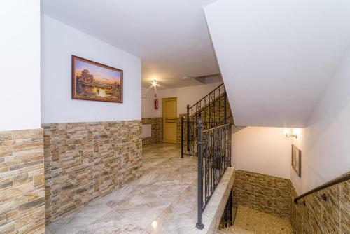 a staircase in a house with a stone wall at Dom wczasowy Anna Maria in Sierockie