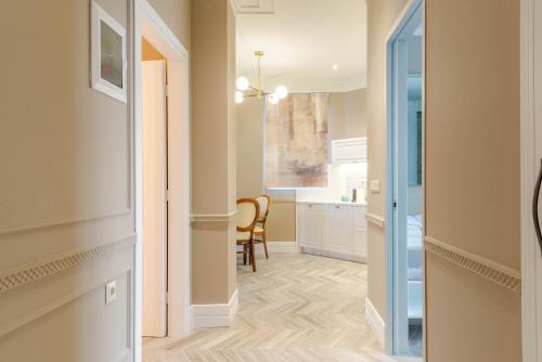 a hallway with a door leading into a room with a kitchen at Ormos Luxury Suites Ammos in Ormos Panagias