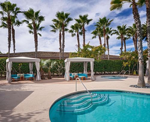
a swimming pool and a beach with palm trees at Hyatt Regency Mission Bay Spa and Marina in San Diego
