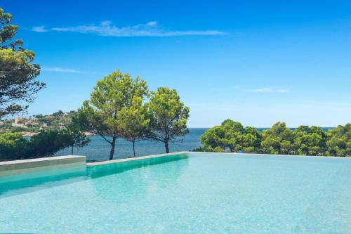 a swimming pool with a view of the ocean at Iberostar Selection Jardín del Sol Suites - Adults Only in Santa Ponsa