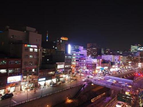 a view of a city at night with lights at Cheonggye Haus in Seoul