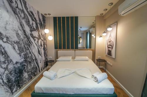 a bedroom with a bed with a bow on it at Haris Luxury Apartment no.4 in Tirana