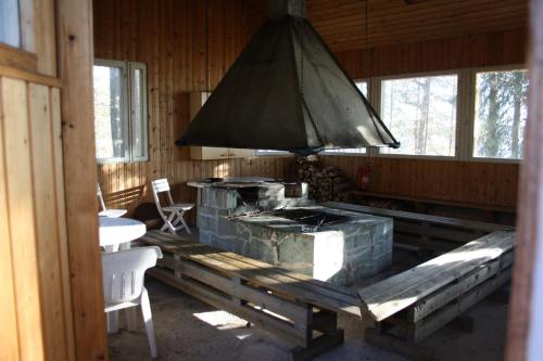 a kitchen with a large grill in a cabin at Lohijärven Eräkeskus in Lohijärvi