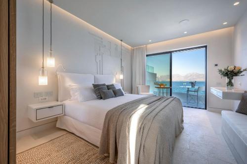 a bedroom with a bed and a view of the ocean at The Island Concept Luxury Boutique Hotel Heated Pool in Agios Nikolaos