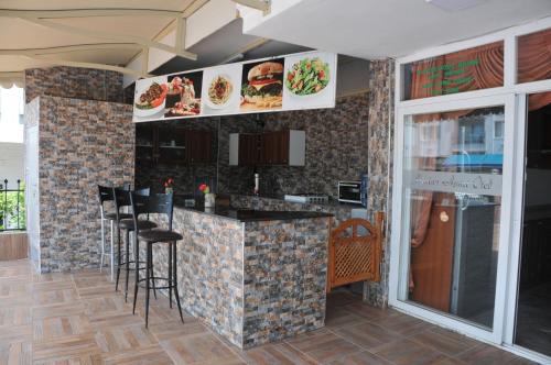 A kitchen or kitchenette at Marina Apart Hotel