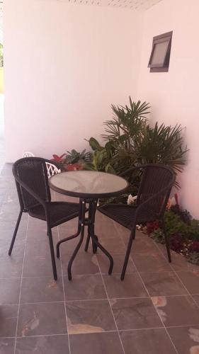 a table and two chairs sitting next to a table at Nalin Place in Ranong