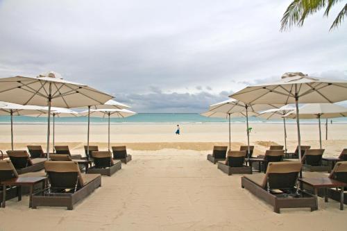 
a beach area with chairs, umbrellas and tables at Two Seasons Boracay Resort in Boracay
