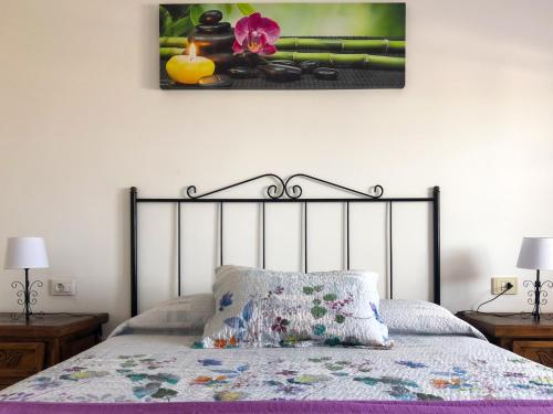 a bedroom with a bed with a picture on the wall at Panoramic View Balcón del Atlántico in Adeje