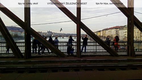 a group of people walking on a bridge at Guest House Prague Airport in Prague