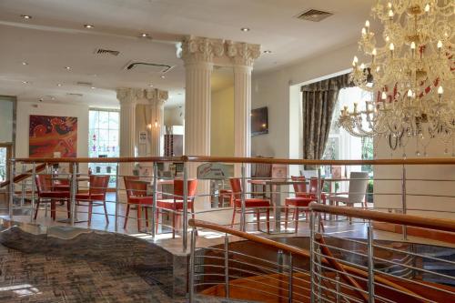 a large room filled with tables and chairs at Corus Hyde Park Hotel in London