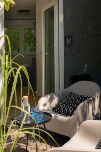 a patio with a chair and a table with a glass table at Apartamenty Na Klifie Przystań 18 Chłapowo in Władysławowo