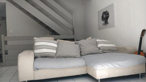 a couch sitting in a living room with a guitar at Chalet Étoile des neiges in Barèges